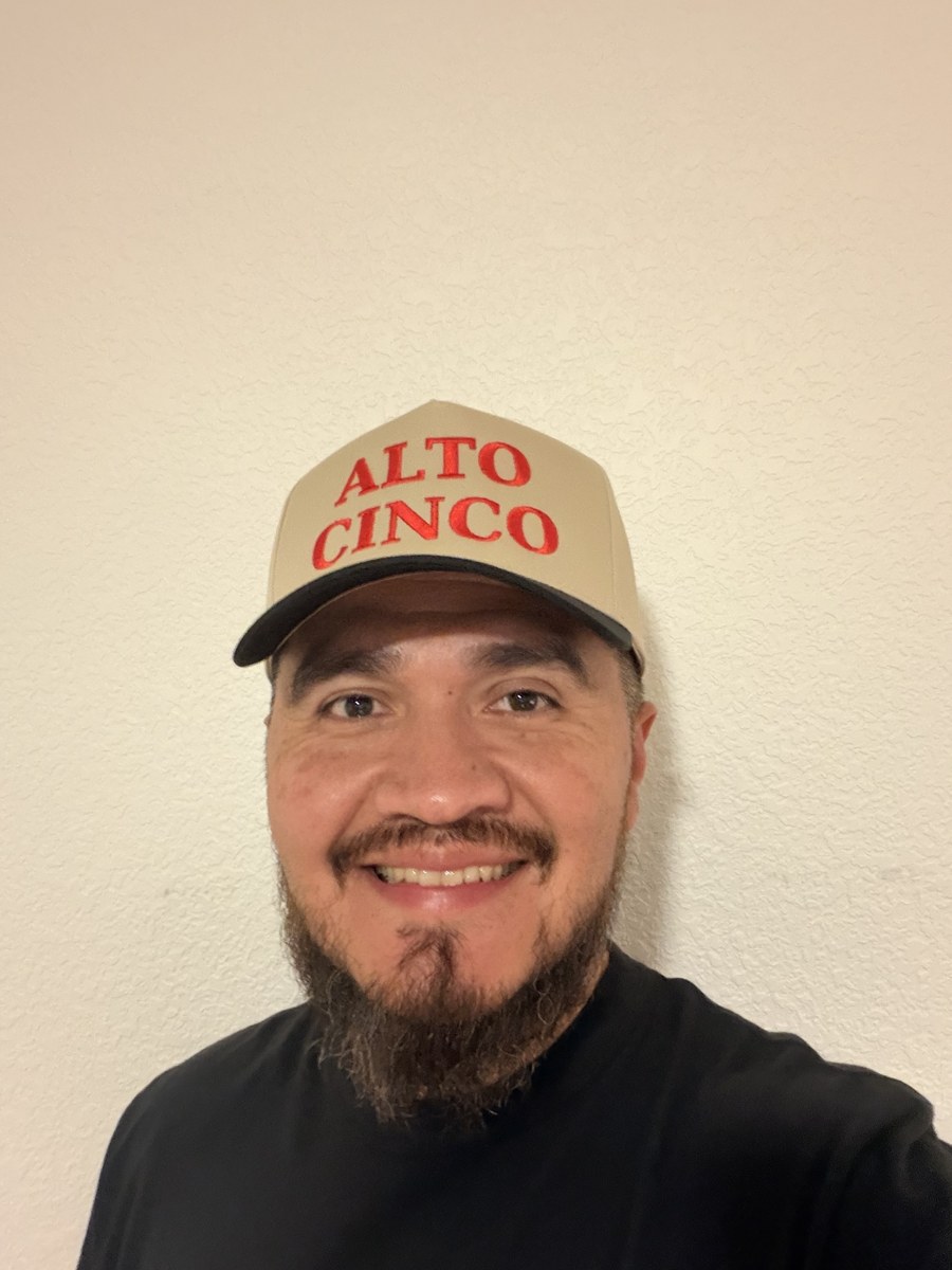 Frank Enriquez, founder of Alto Cinco, wearing an Alto Cinco hat